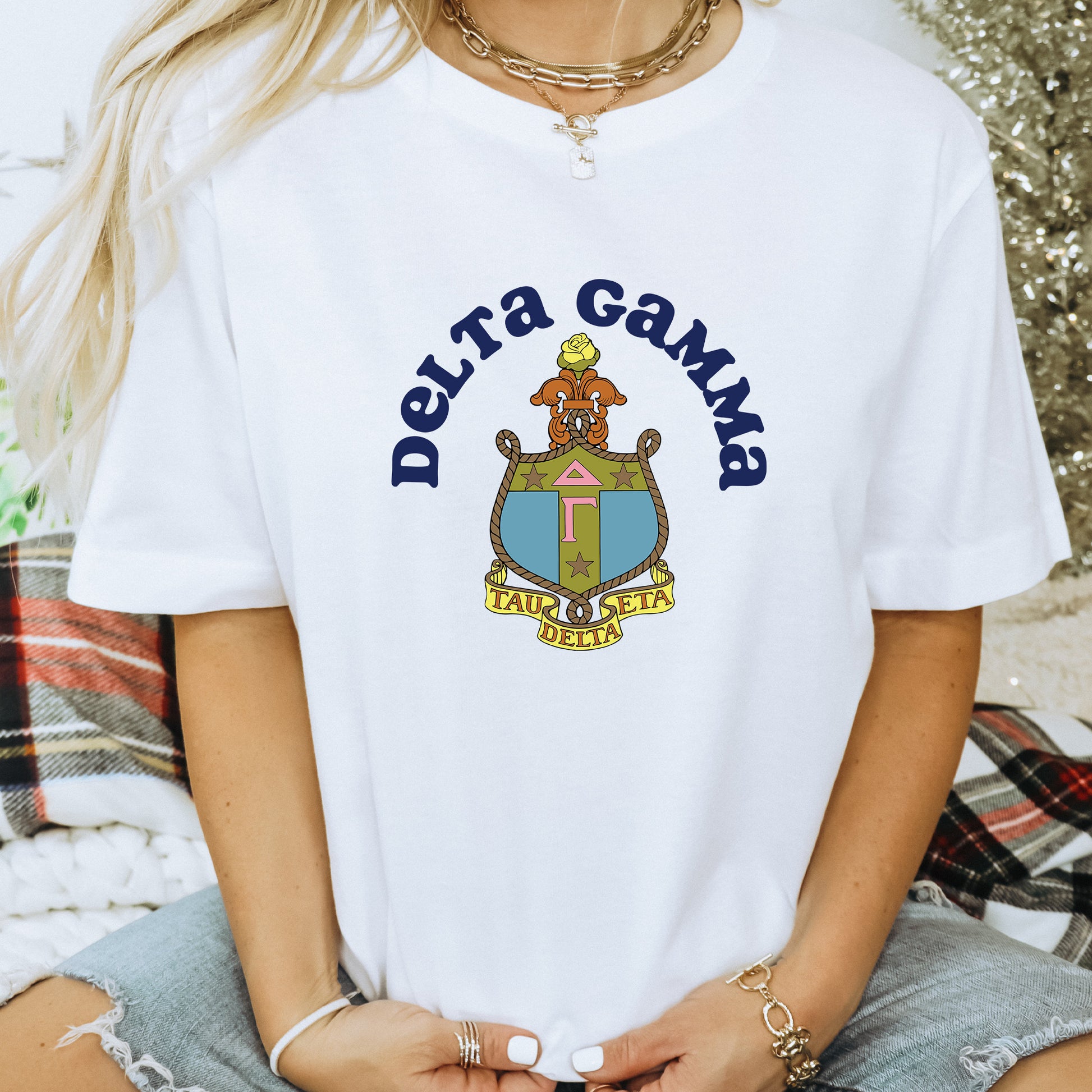 a woman wearing a white shirt with the words delta gama on it