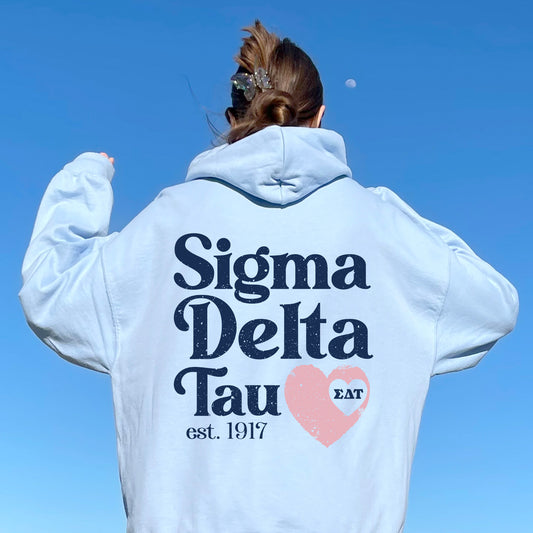 a woman wearing a white sweatshirt with a heart on it