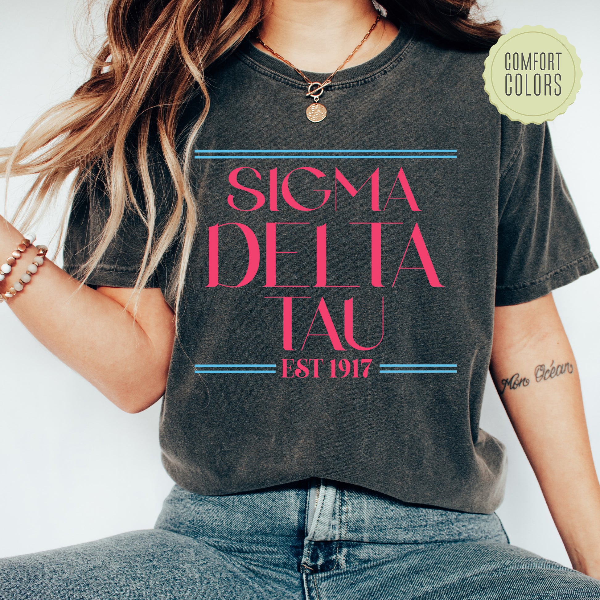 a woman wearing a t - shirt that says signa delta tau est 1917