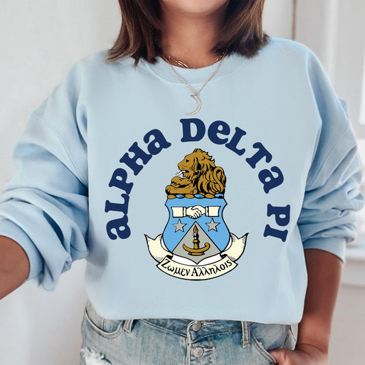 a woman wearing a blue sweatshirt with a lion on it