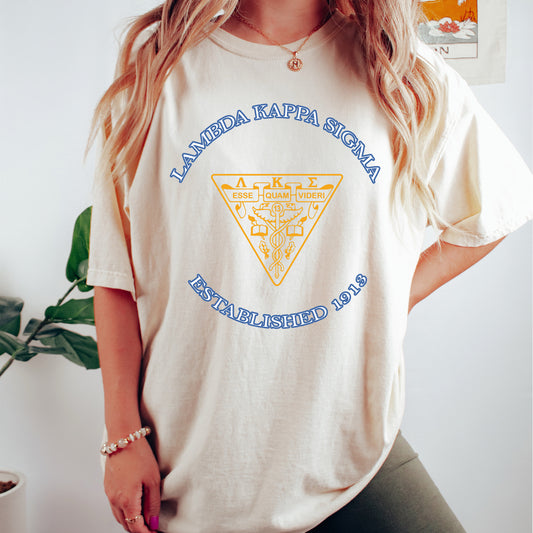a woman wearing a white t - shirt with a blue and yellow triangle on it