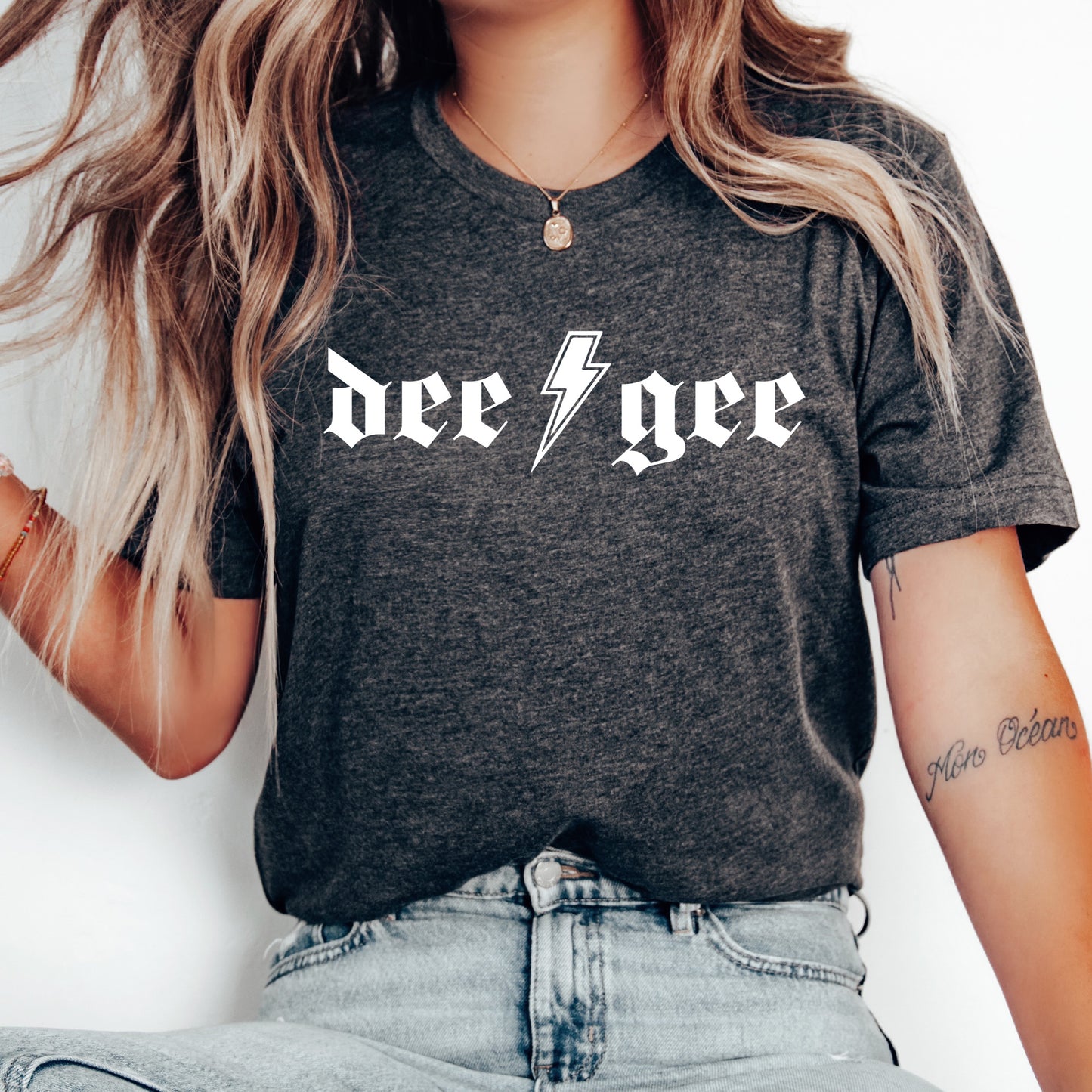 a woman wearing a t - shirt with a lightning bolt on it
