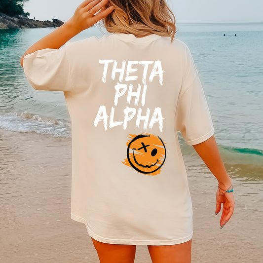 a woman standing on a beach wearing a white shirt