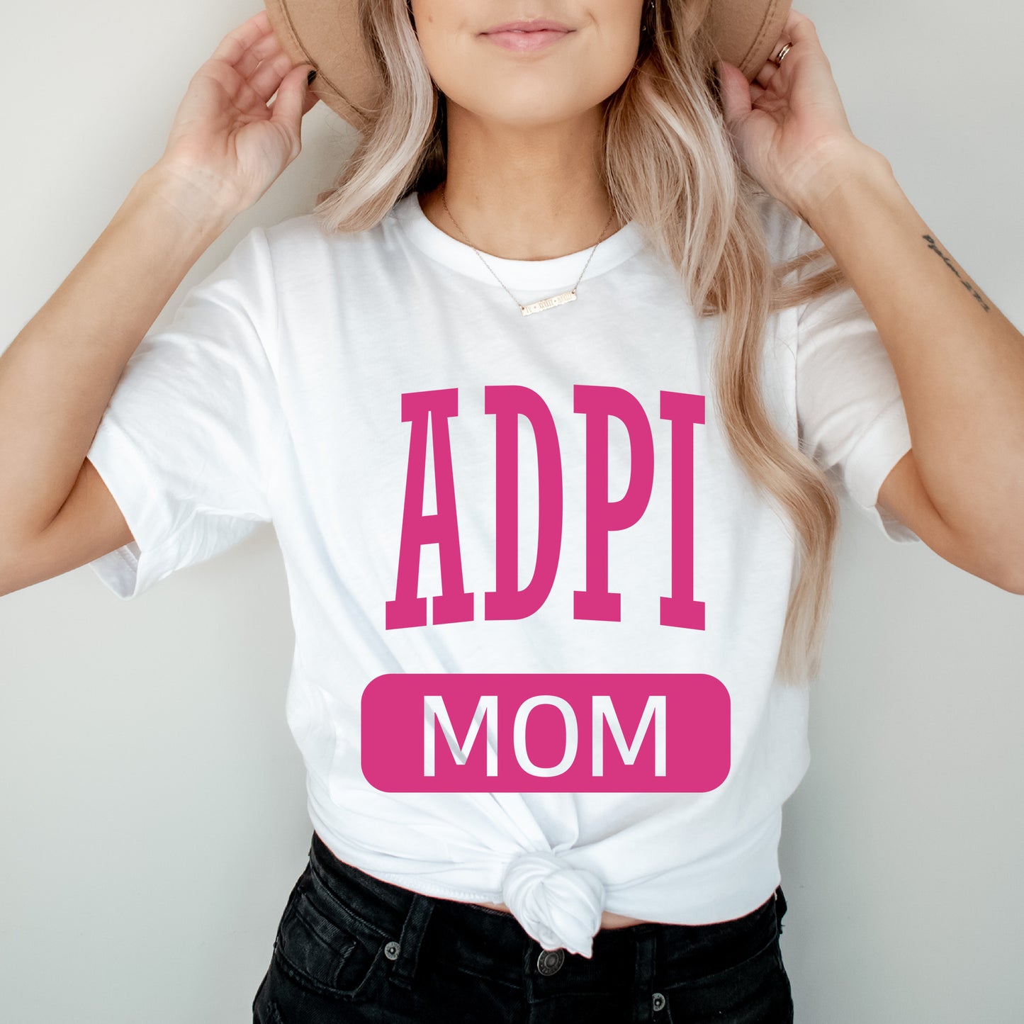 a woman wearing a t - shirt that says adopt mom