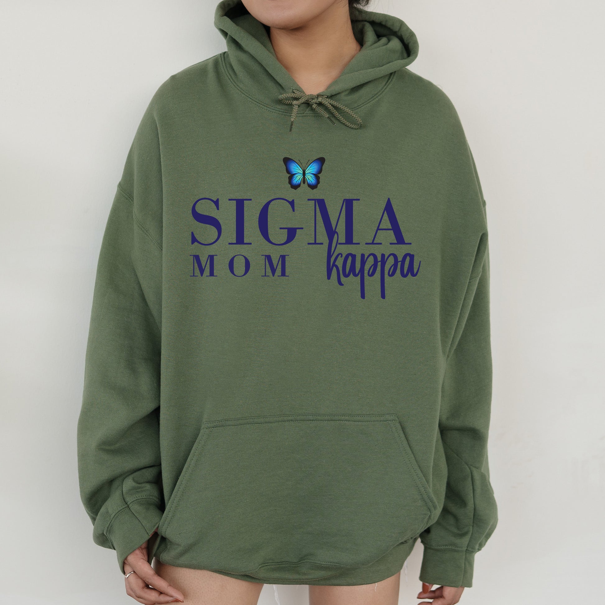 a woman wearing a green hoodie with a butterfly on it