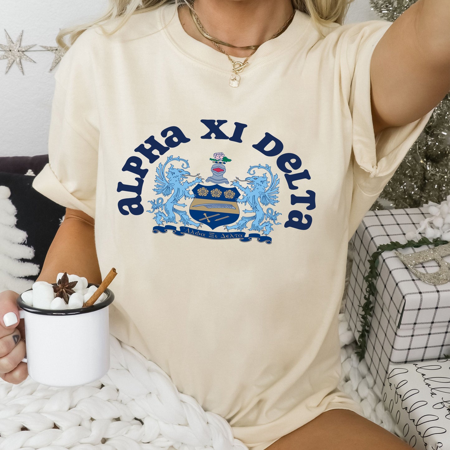 a woman sitting on a bed holding a cup of coffee