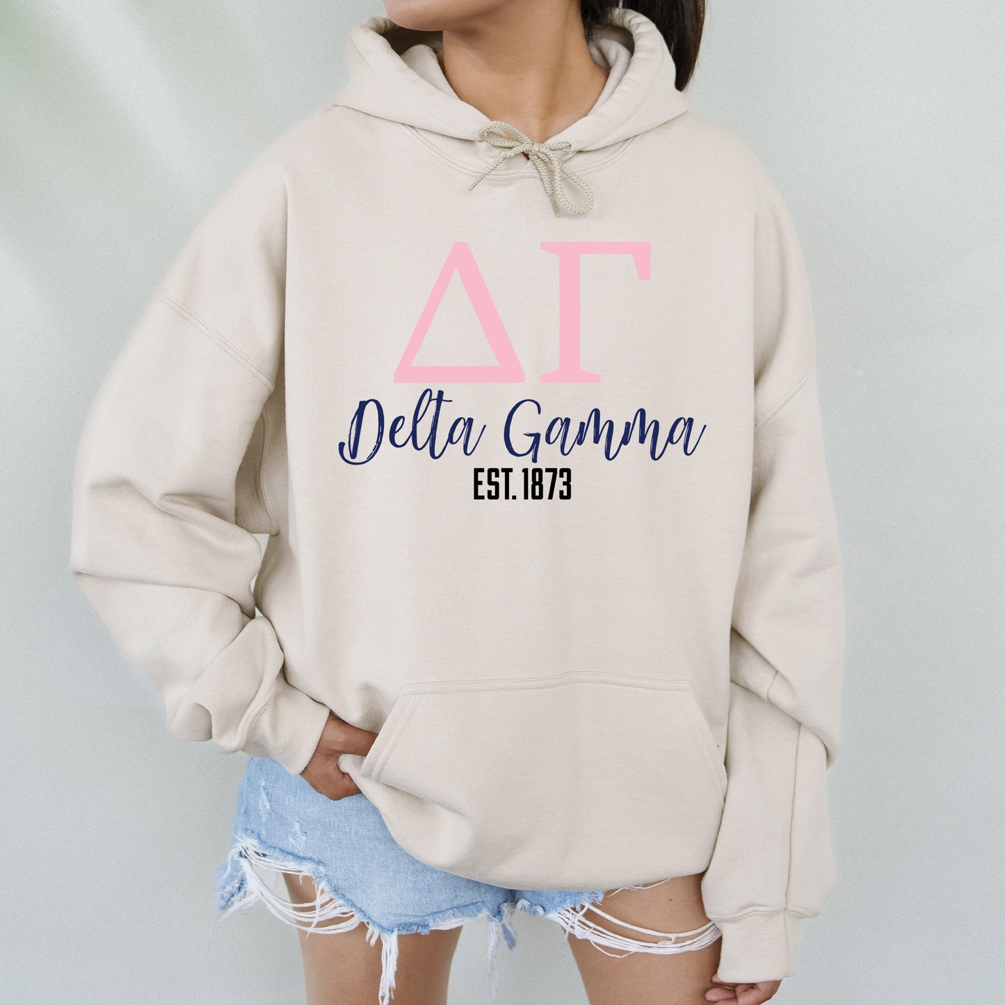 a woman wearing a hoodie with the delta gama on it