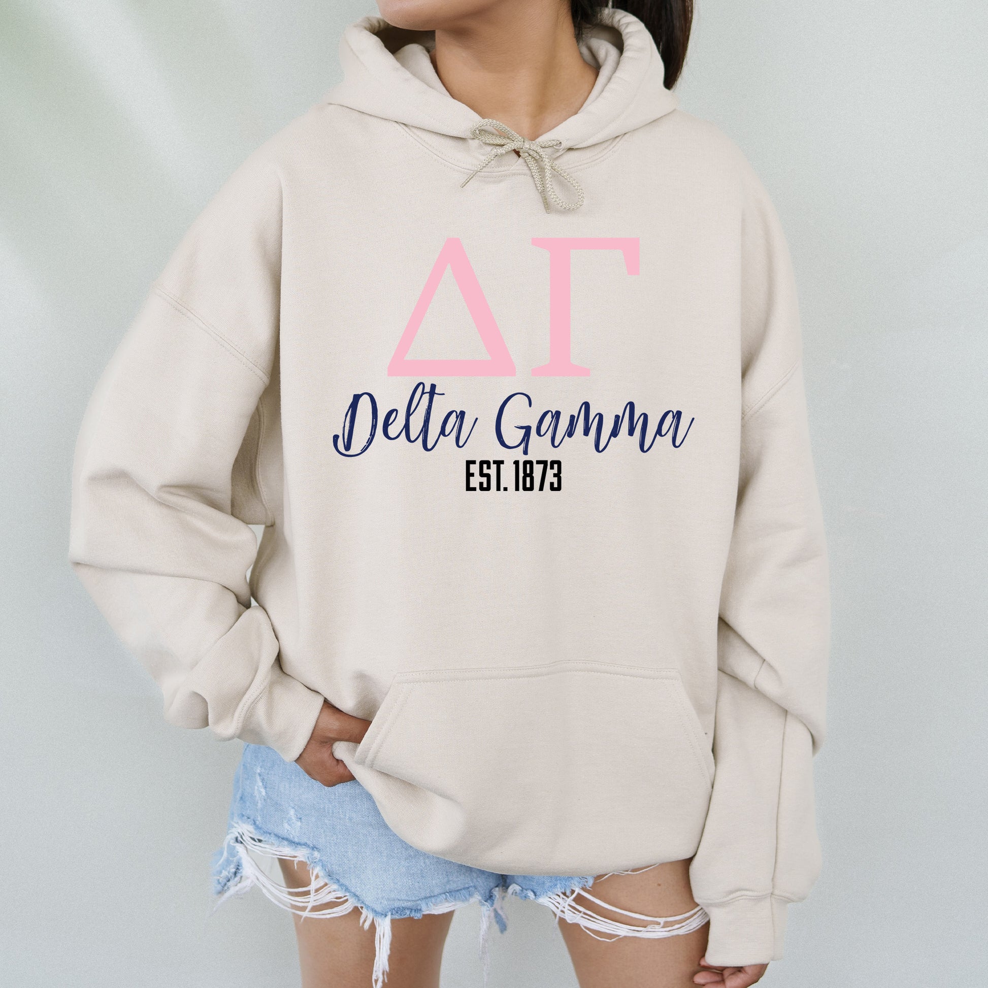 a woman wearing a hoodie with the delta gama on it