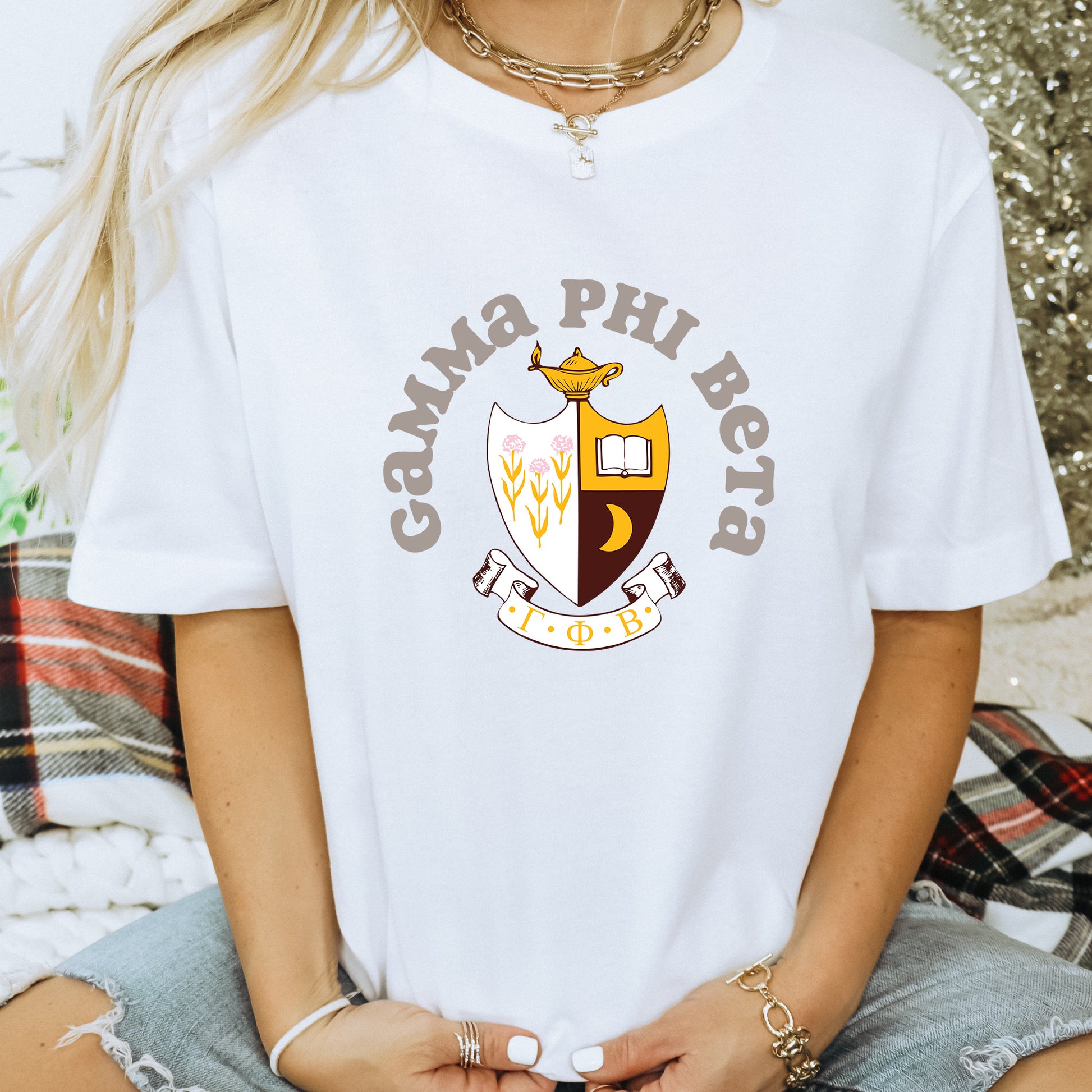 a woman wearing a white shirt with a crest on it