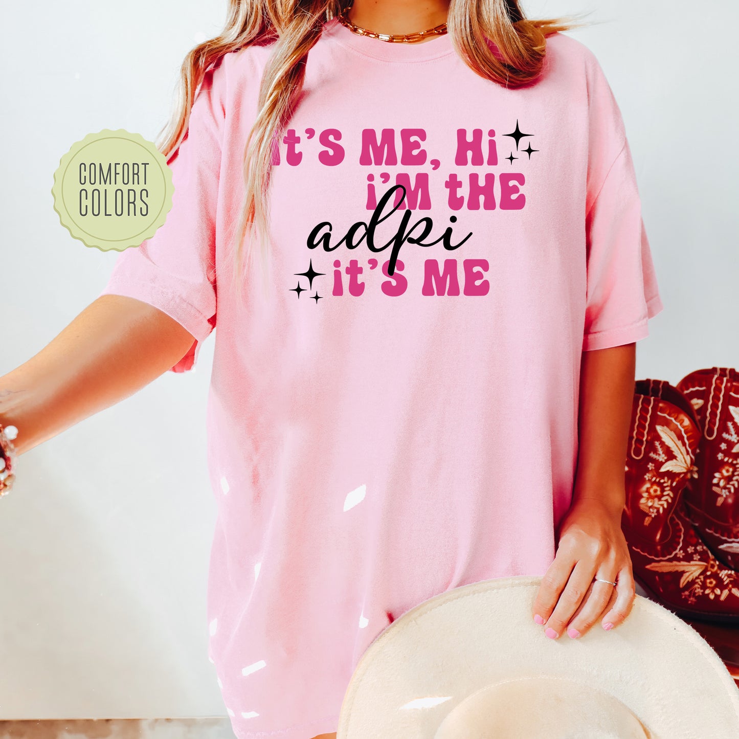 a woman wearing a pink shirt that says it's me, he's