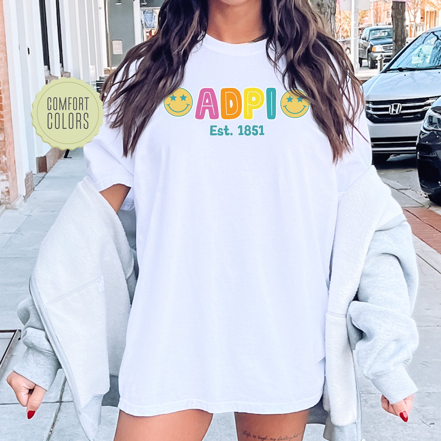 a woman wearing a white shirt with the word appi on it