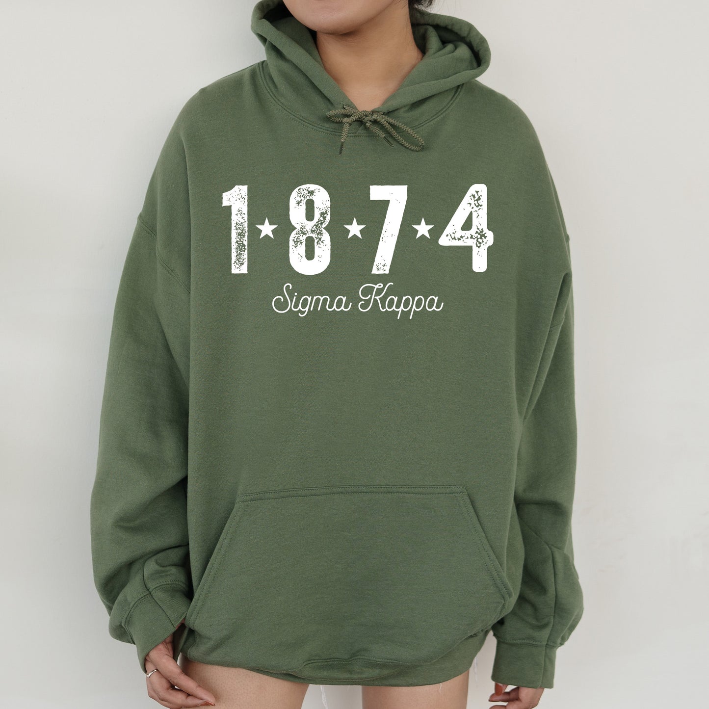 a woman wearing a green hoodie with the number 474 on it