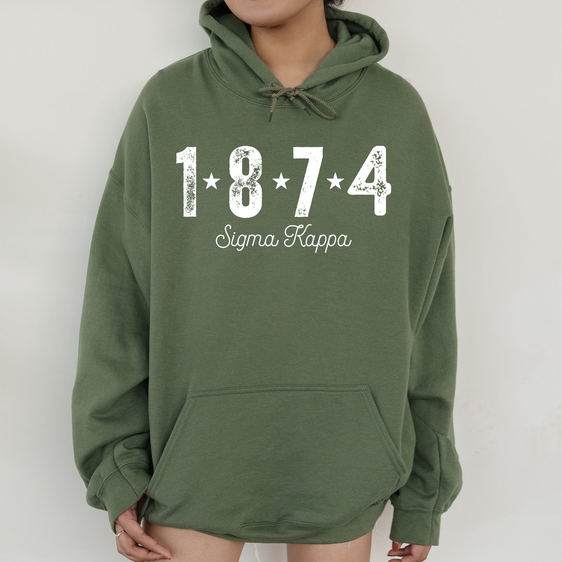 a woman wearing a green hoodie with the number 474 on it