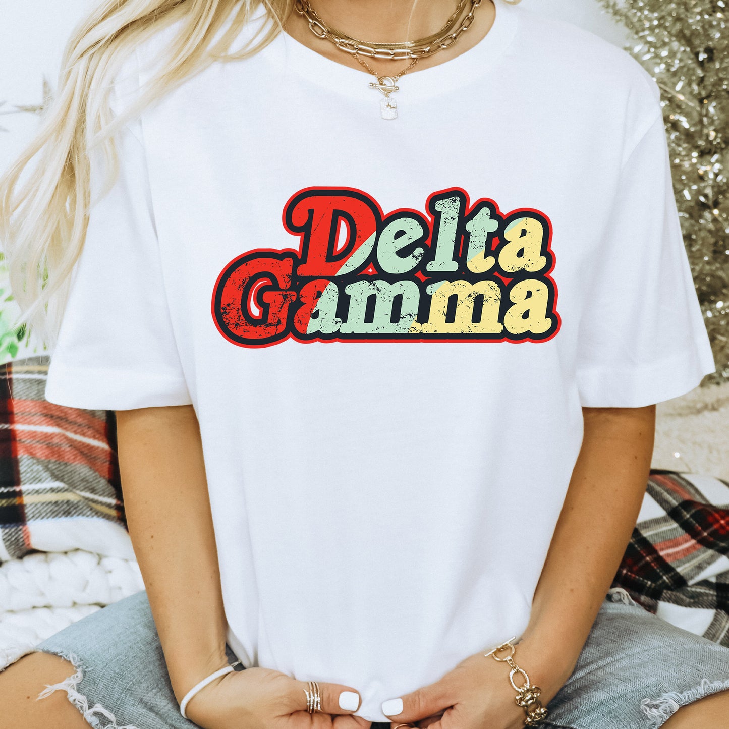 a woman wearing a white shirt with the word delta gumma on it