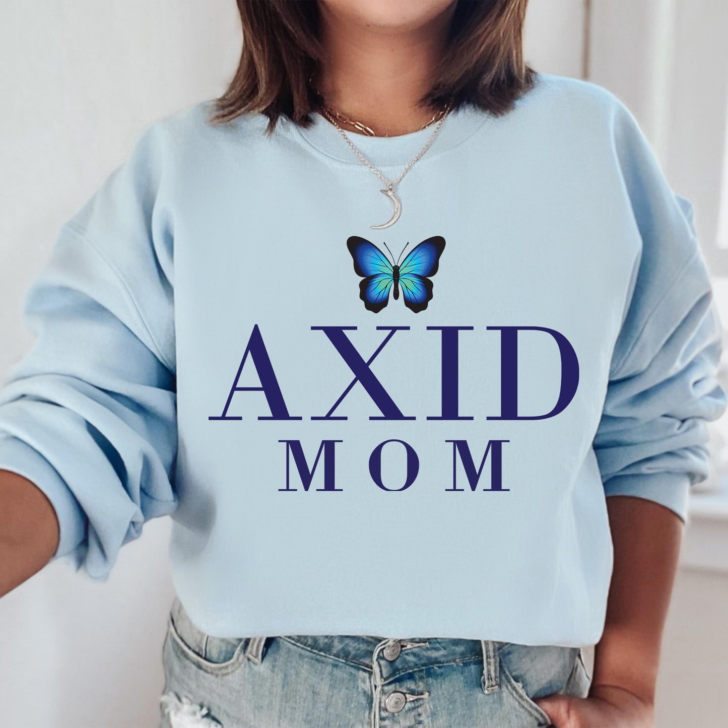 a woman wearing a blue sweatshirt with a butterfly on it