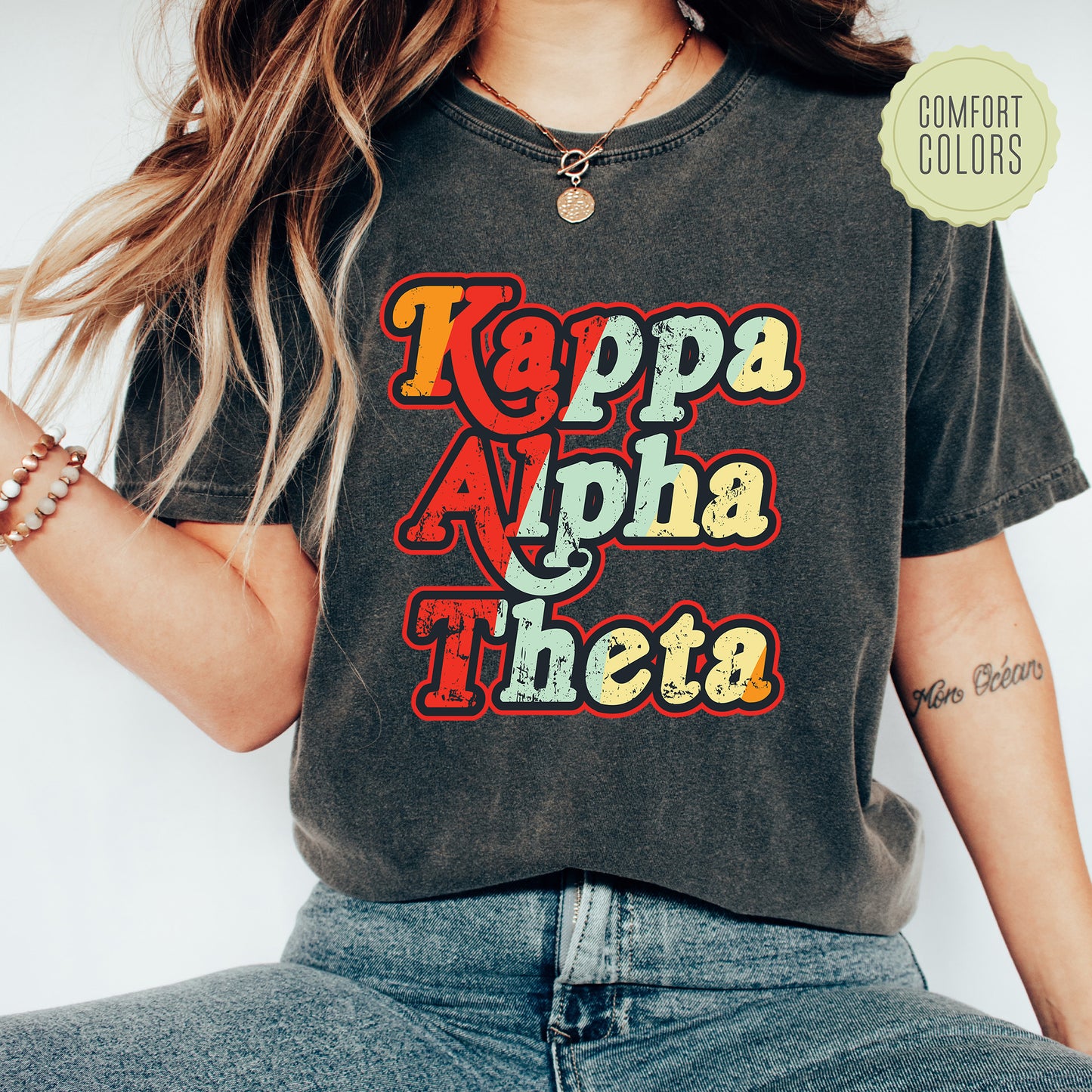 a woman wearing a t - shirt that says kappa apha theea