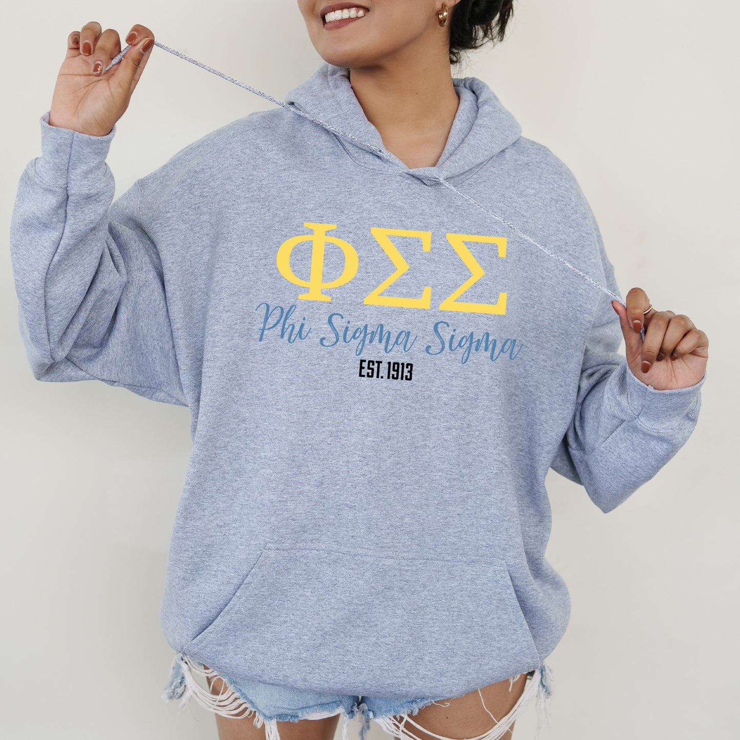 a woman in a blue sweatshirt holding a string