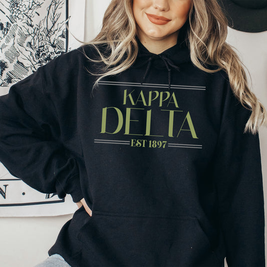 a woman wearing a black kapa delta hoodie