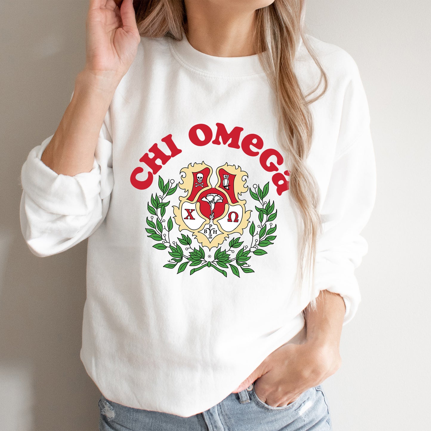 a woman wearing a white sweatshirt with a crest on it