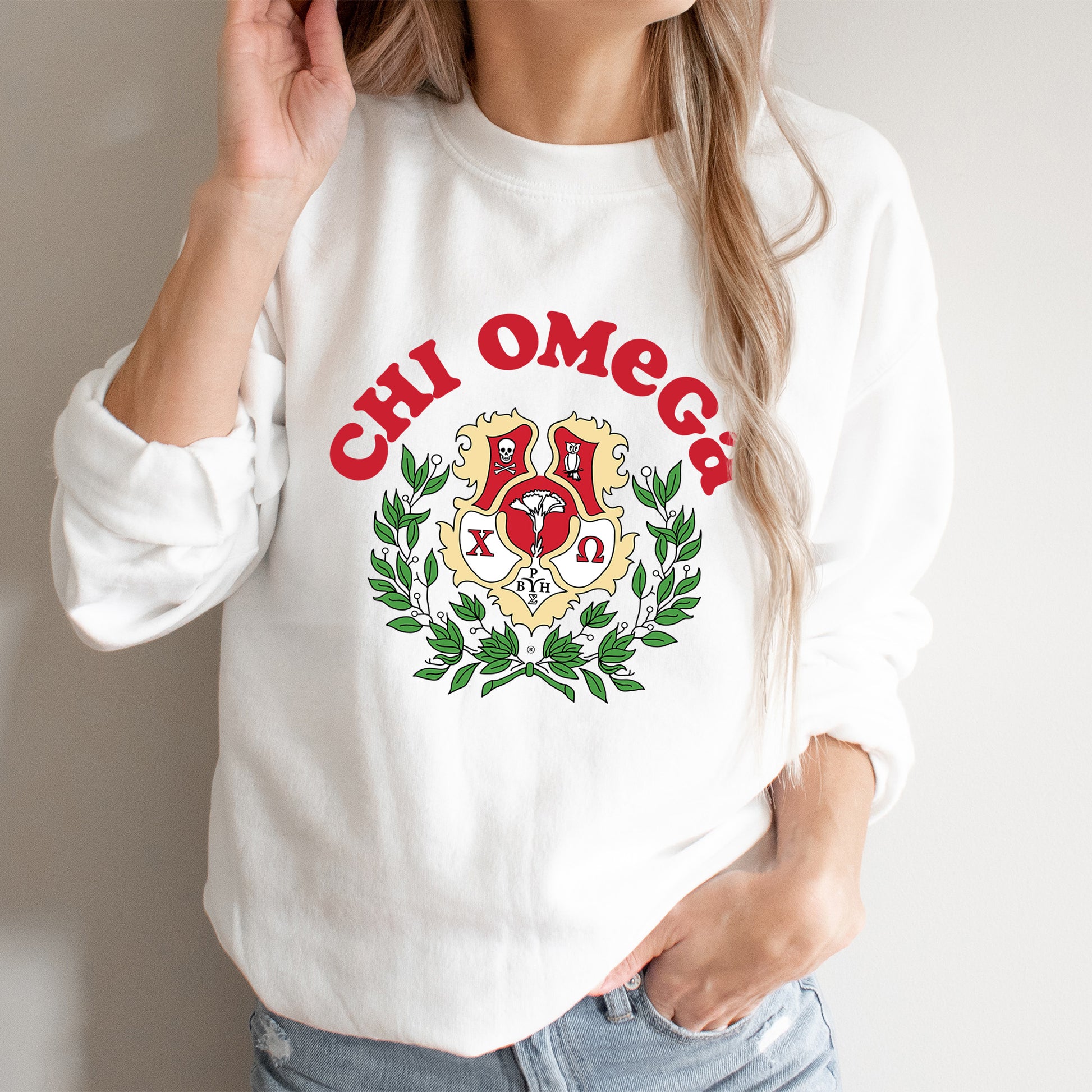 a woman wearing a white sweatshirt with a crest on it