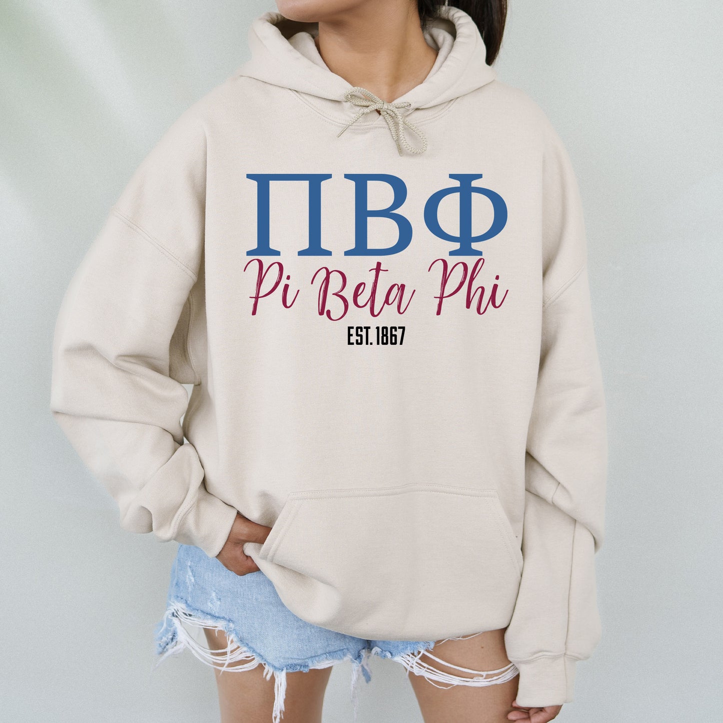 a woman wearing a hoodie that says pi beta phi