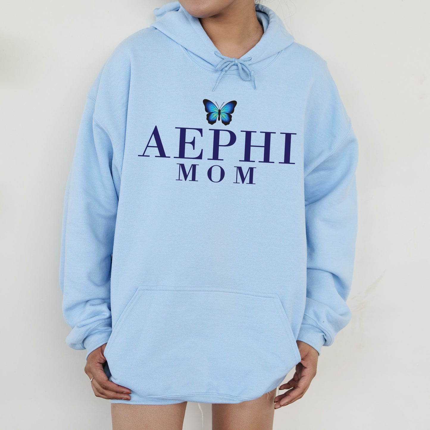 a woman wearing a blue hoodie with a butterfly on it