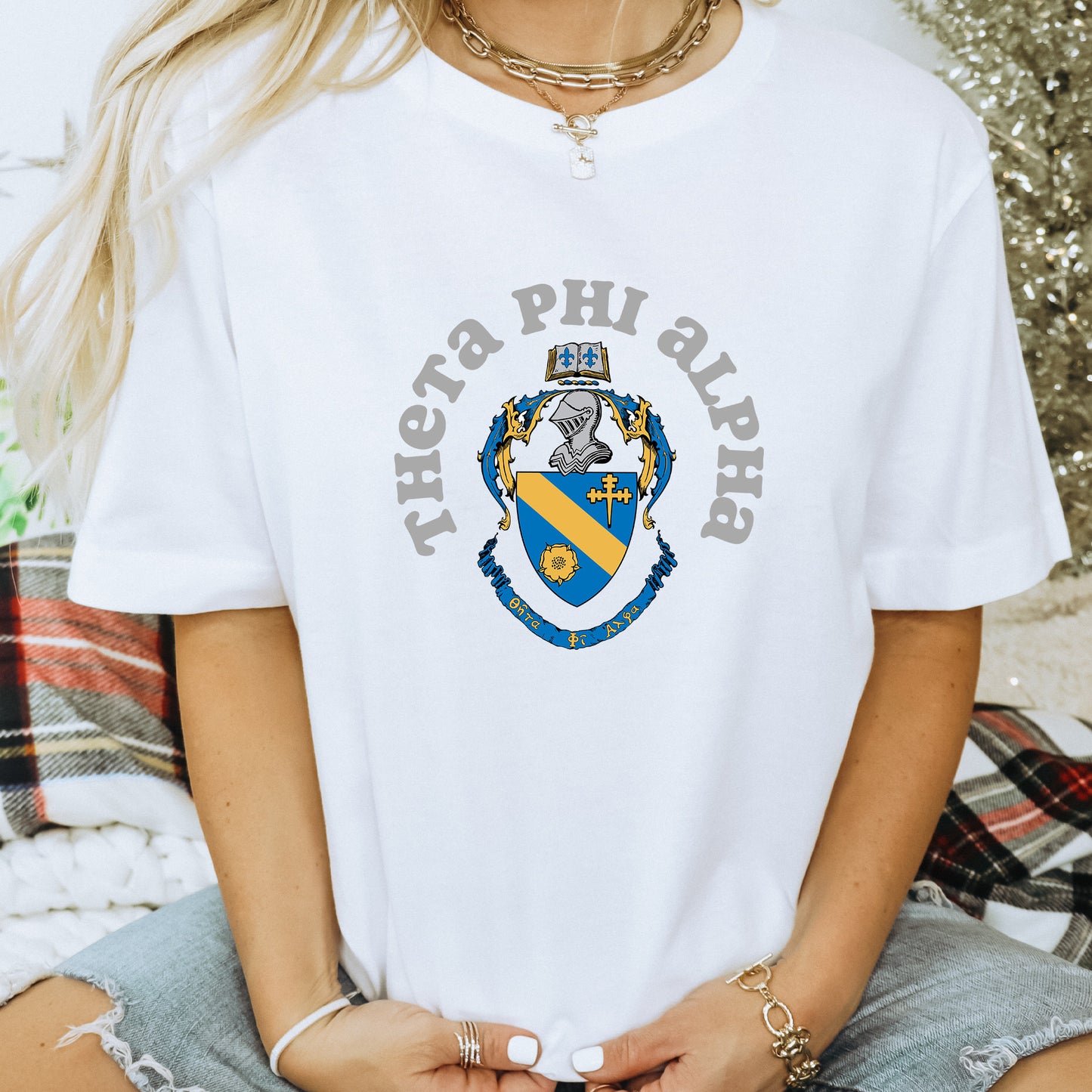 a woman wearing a white phi phi phi t - shirt