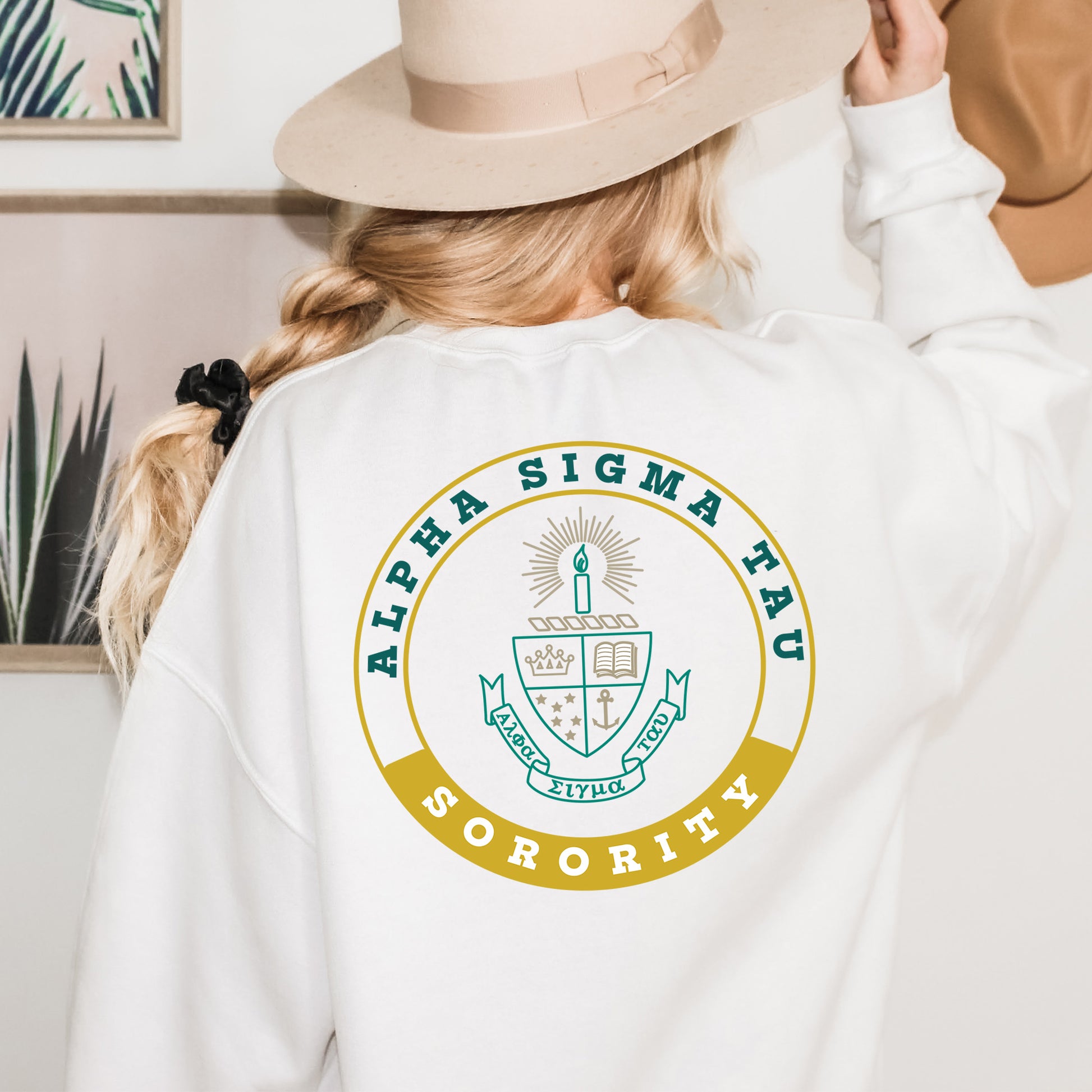a woman wearing a white sweatshirt with a logo on it