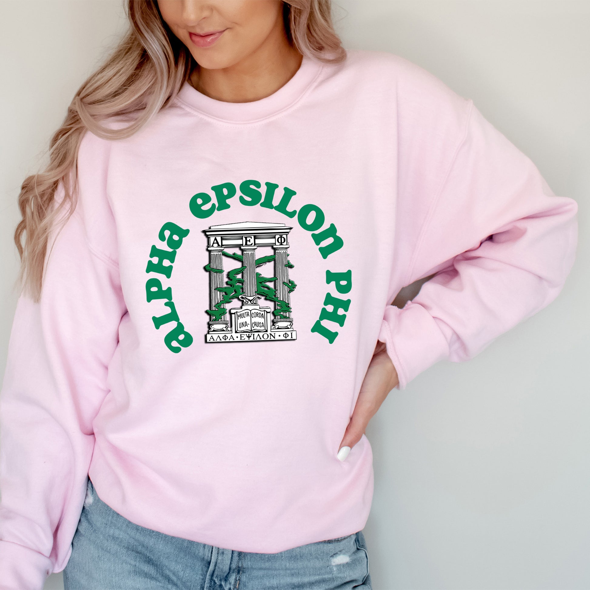a woman wearing a pink sweatshirt with green lettering