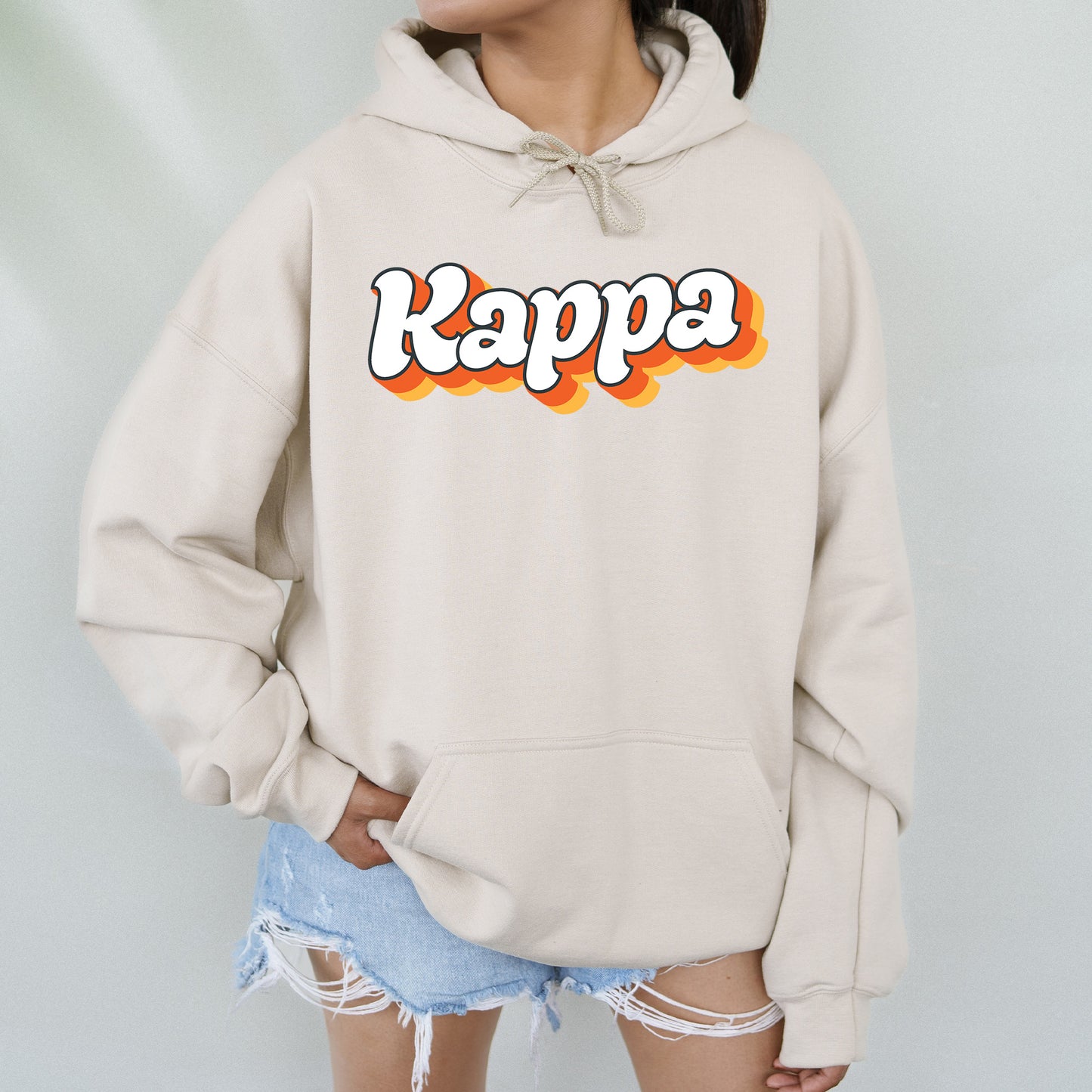 a woman wearing a sweatshirt with the word kappa on it