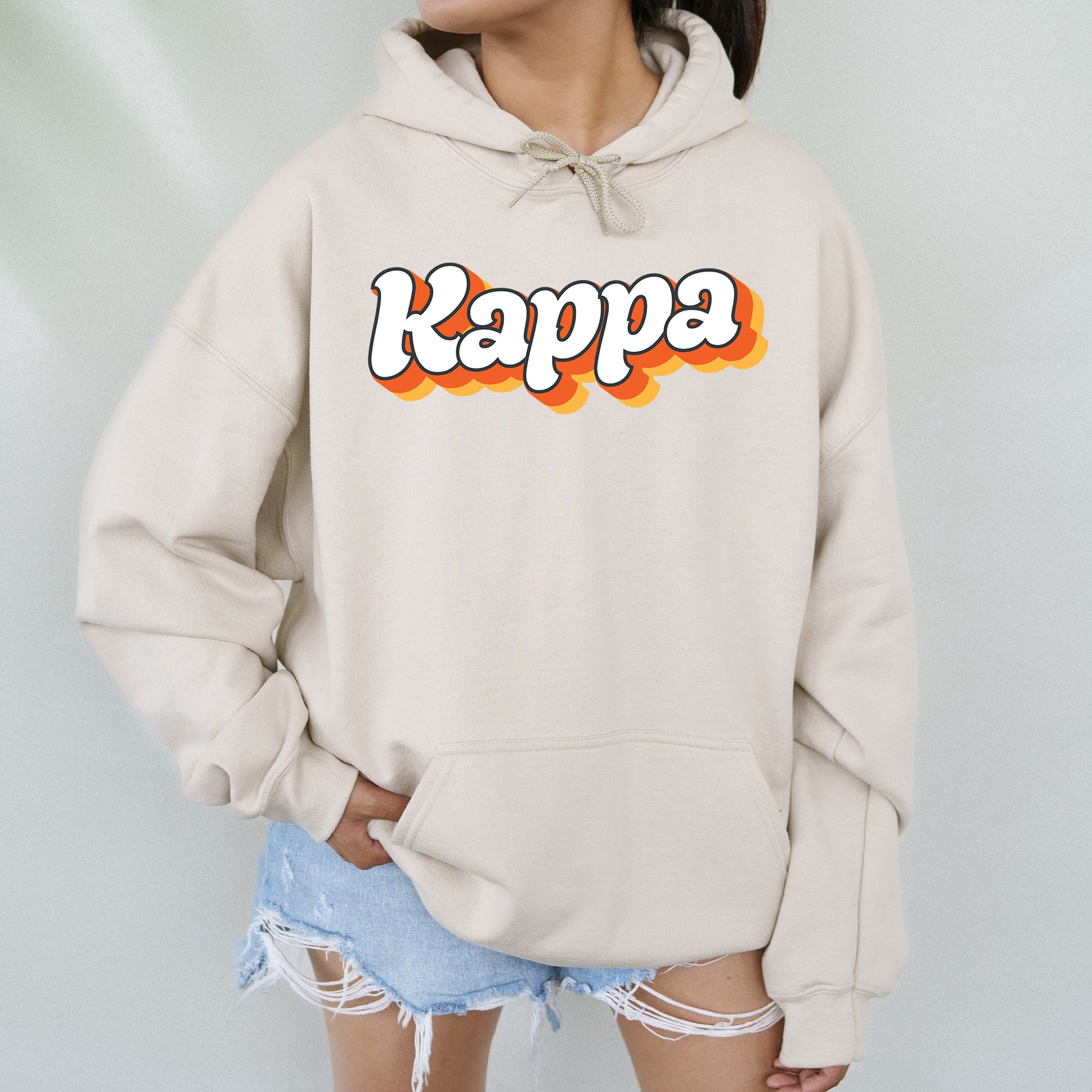 a woman wearing a sweatshirt with the word kappa on it