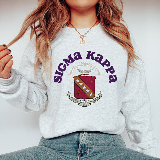 a woman wearing a sweater with a crest on it