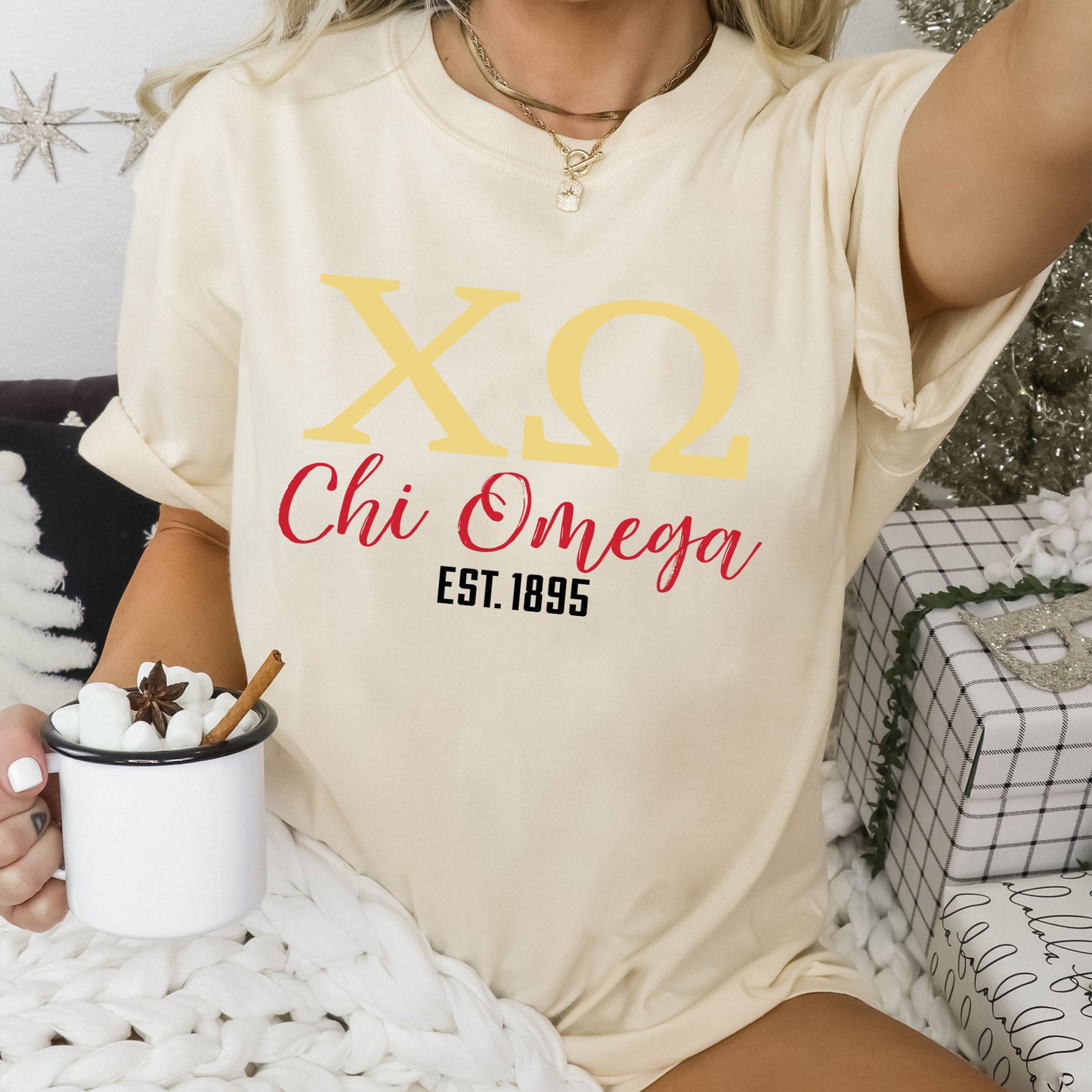 a woman sitting on a bed holding a cup of coffee