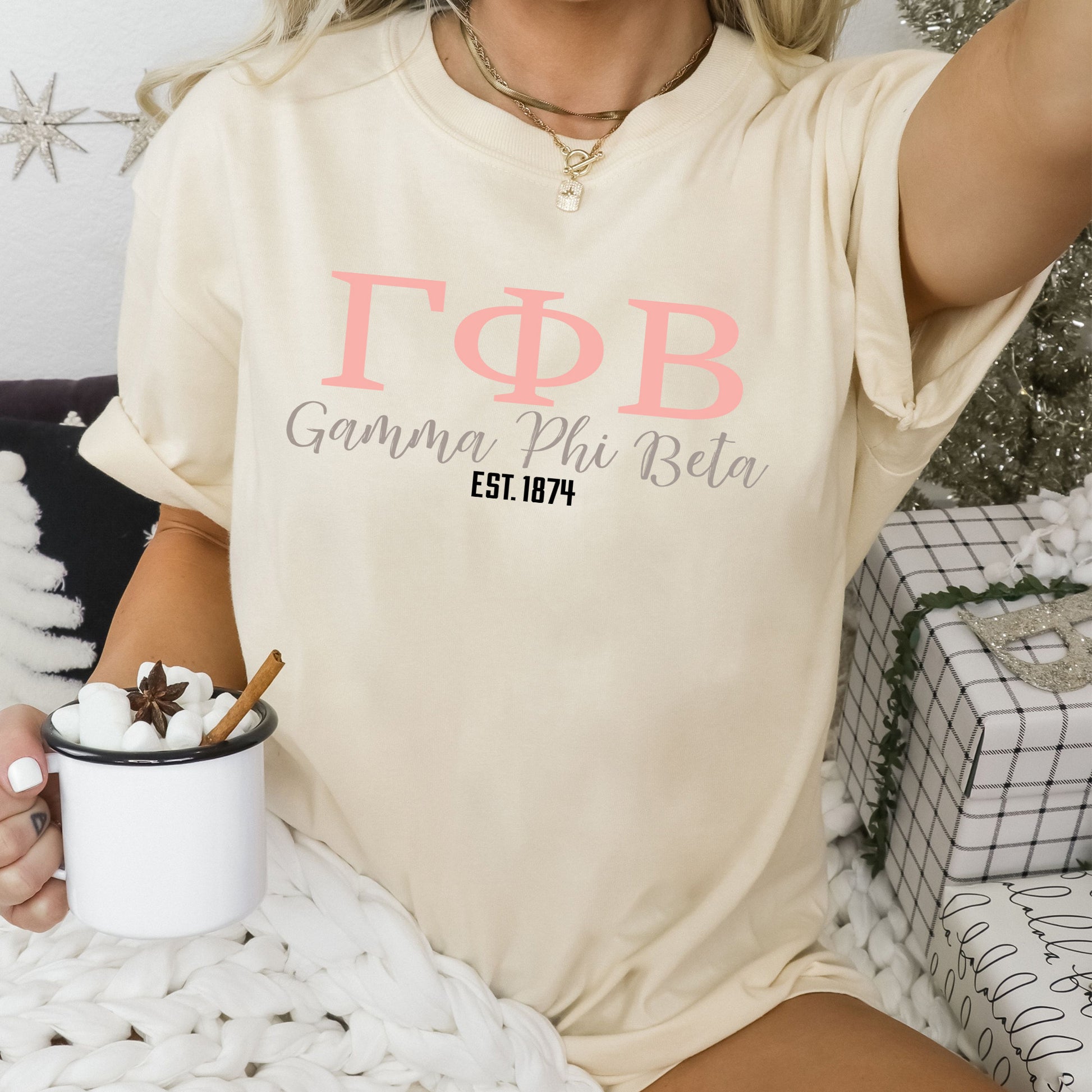 a woman sitting on a bed holding a cup of coffee