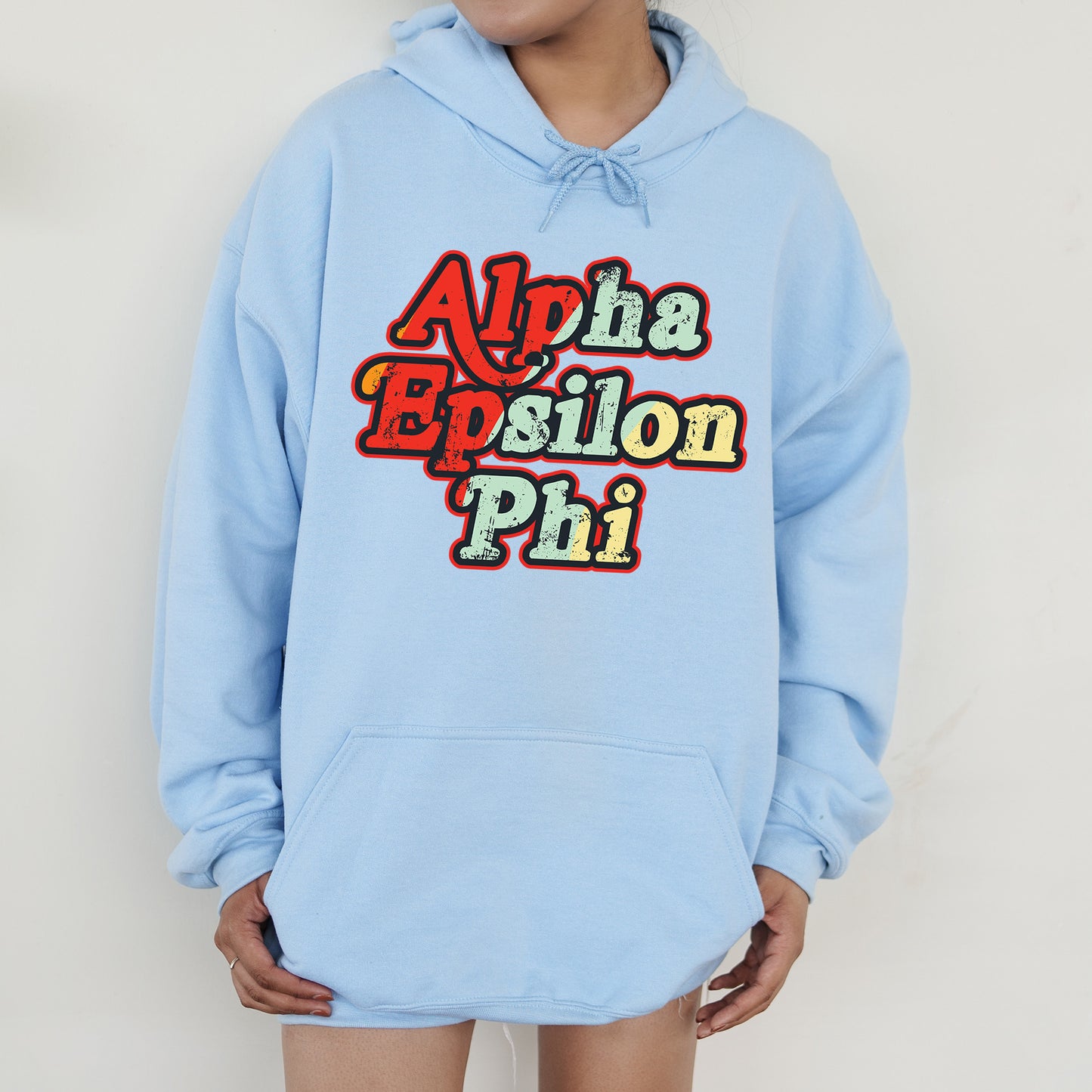 a person wearing a blue hoodie with the words aloha epsilon