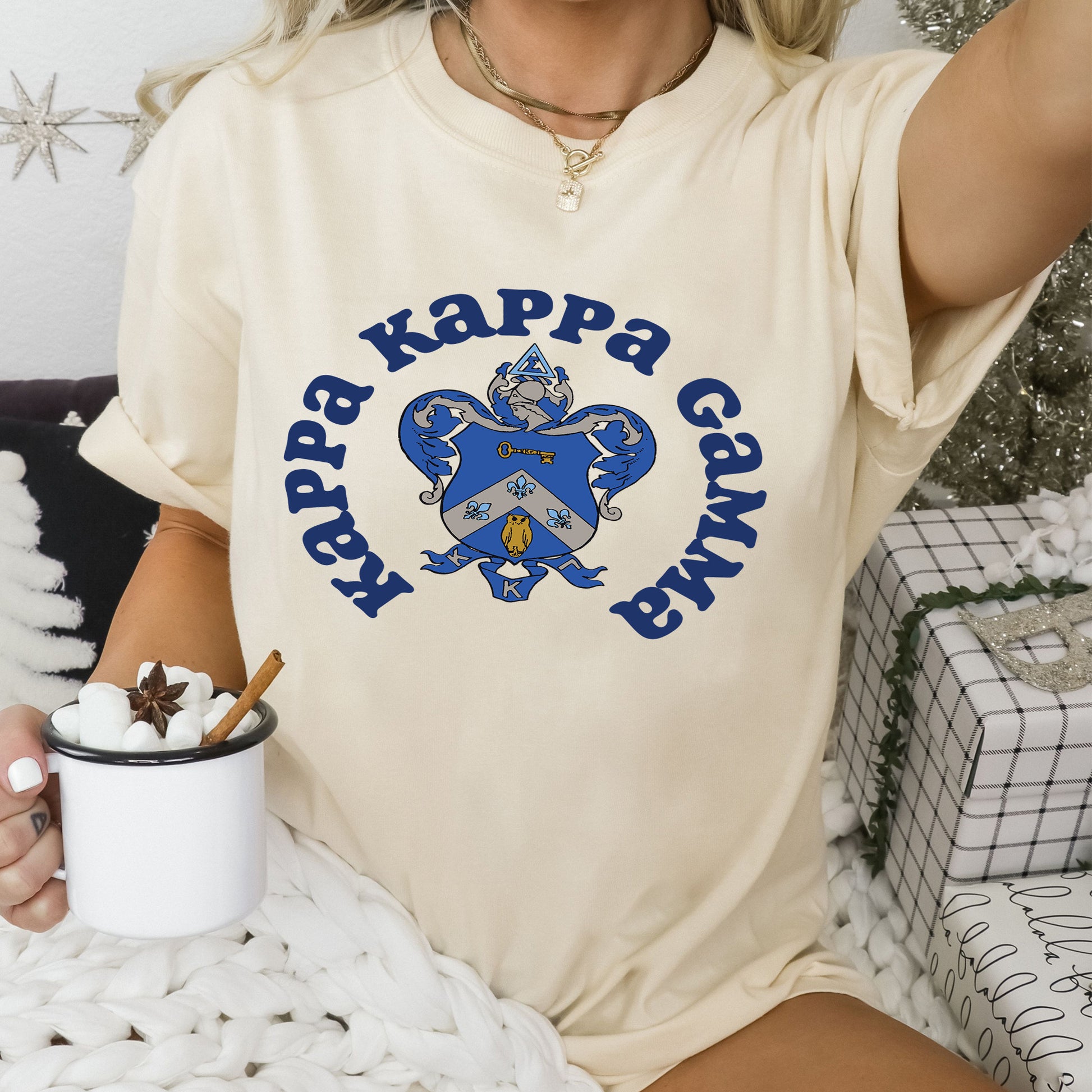 a woman sitting on a bed holding a cup of coffee