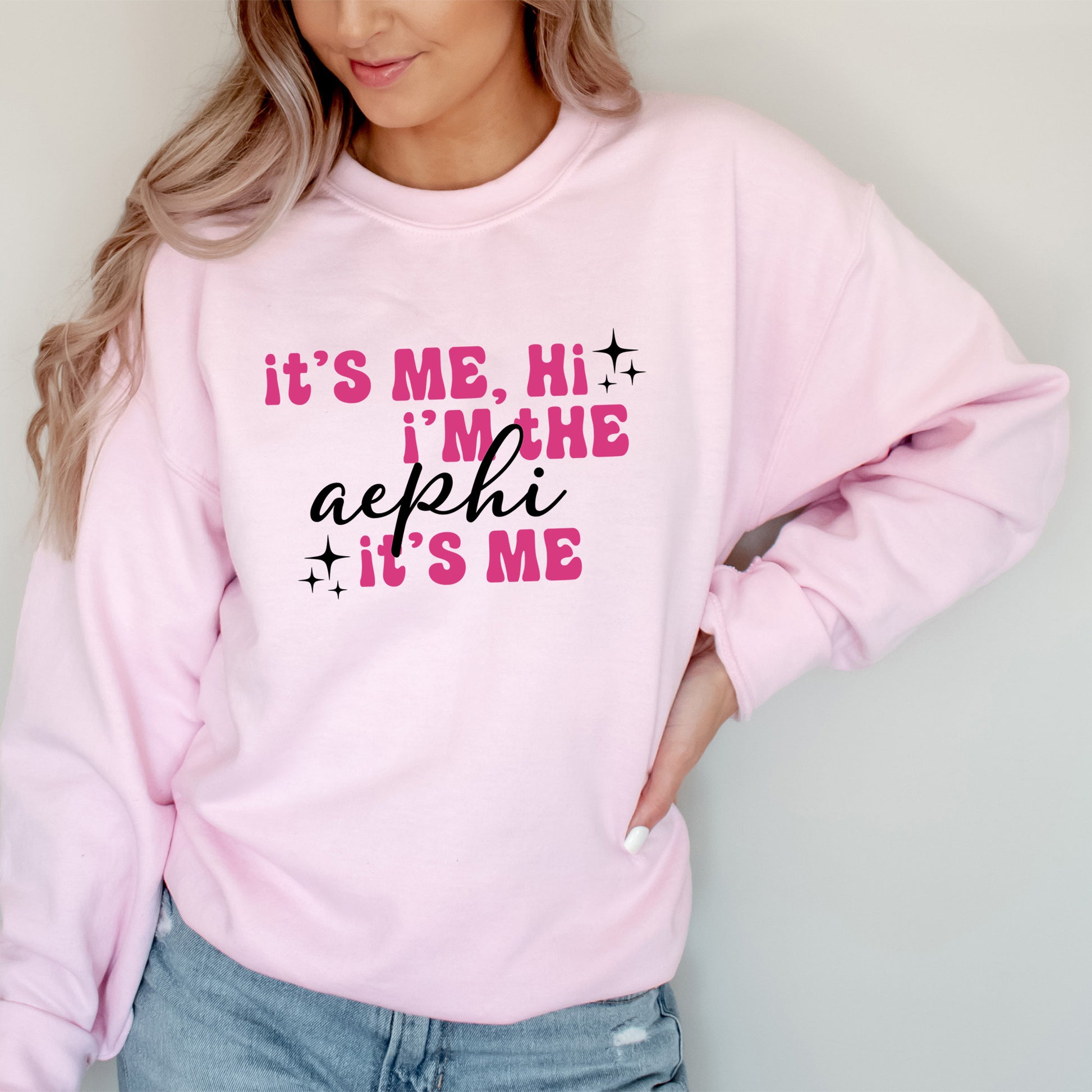 a woman wearing a pink sweatshirt that says it's me, i'm