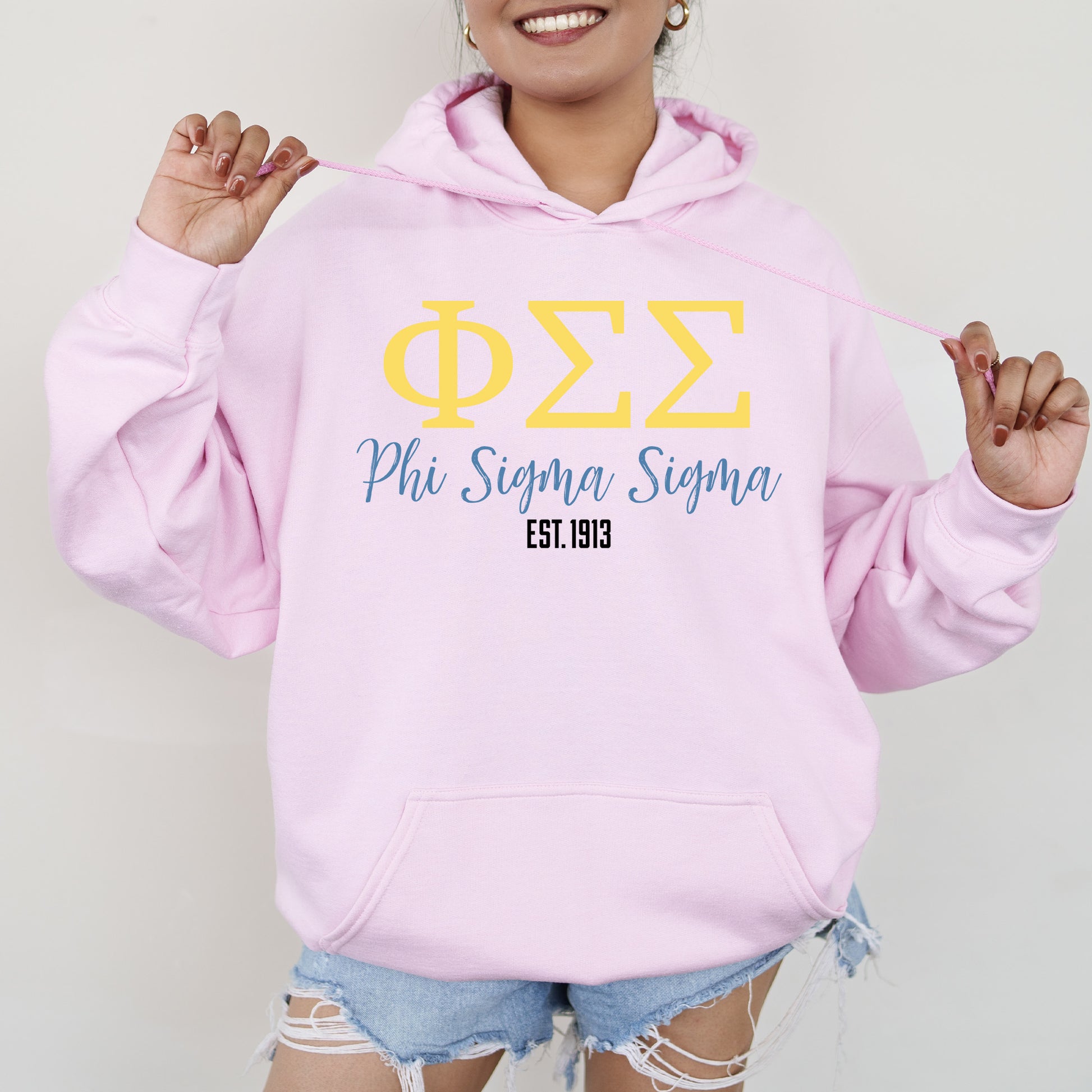 a woman wearing a pink phi phi hoodie
