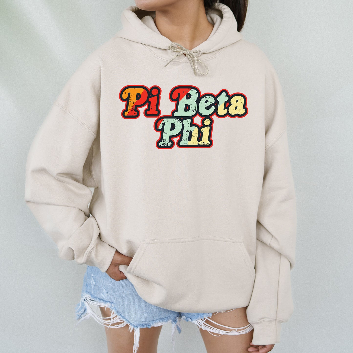 a woman wearing a hoodie with the word pi beta phi on it