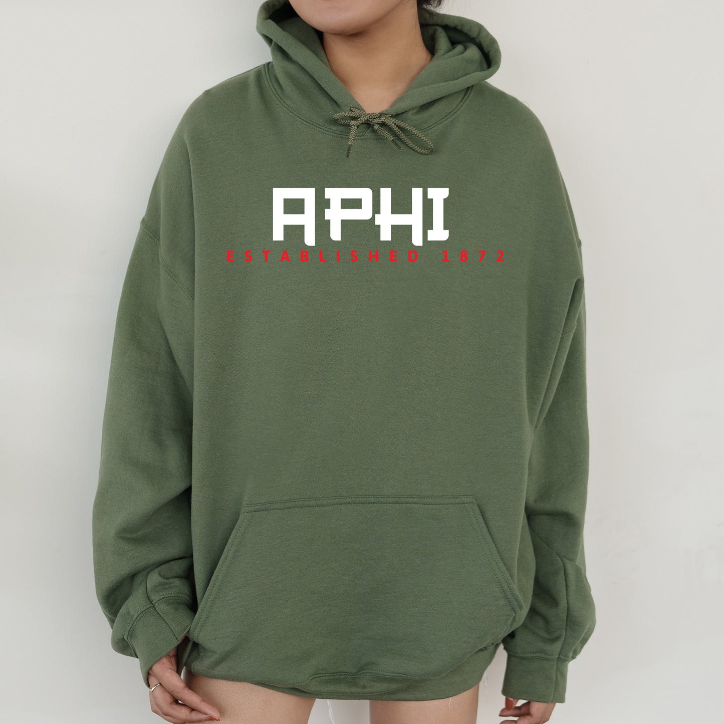 a person wearing a green hoodie with the words aphi on it