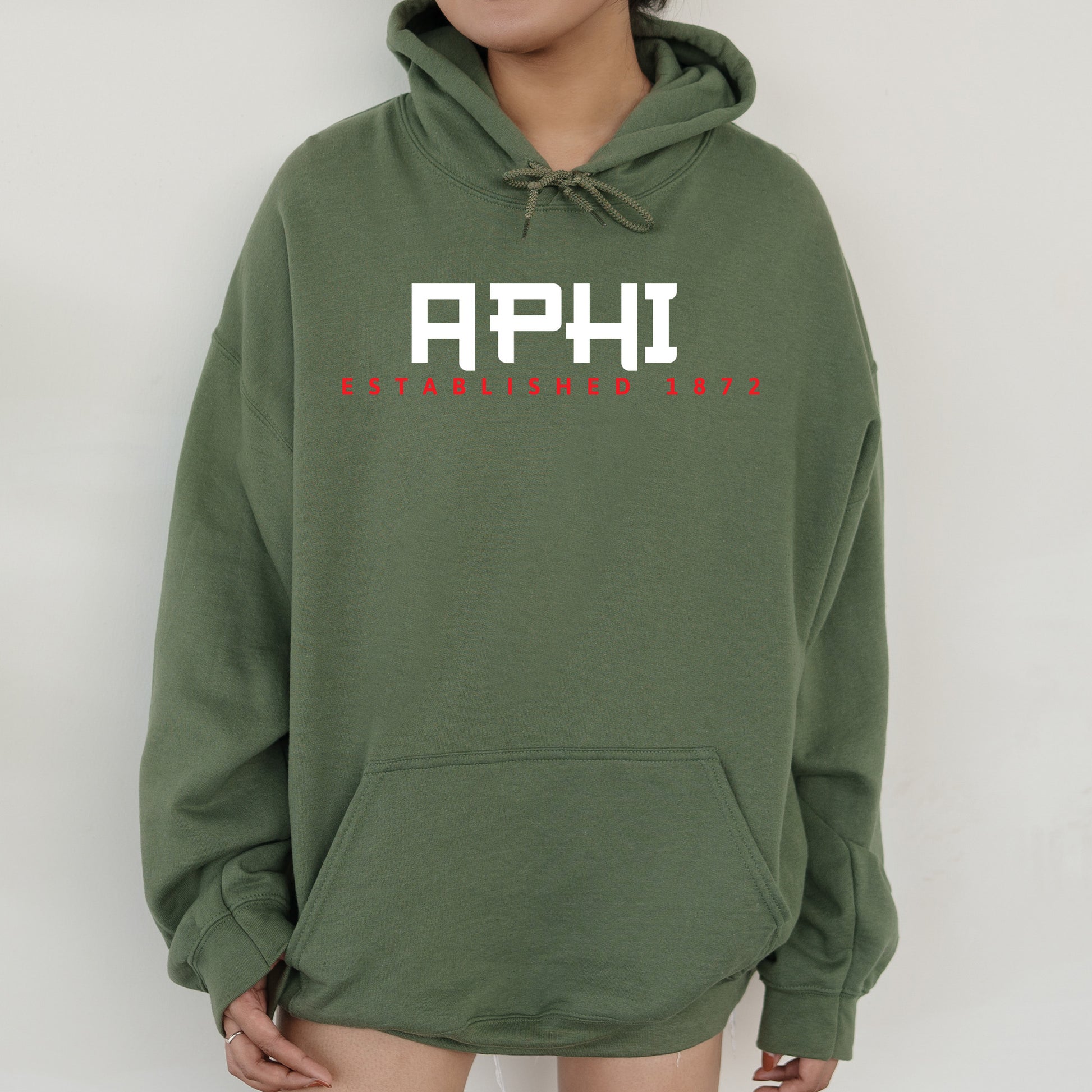 a person wearing a green hoodie with the words aphi on it