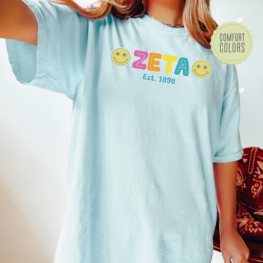 a woman wearing a t - shirt with a smiley face on it