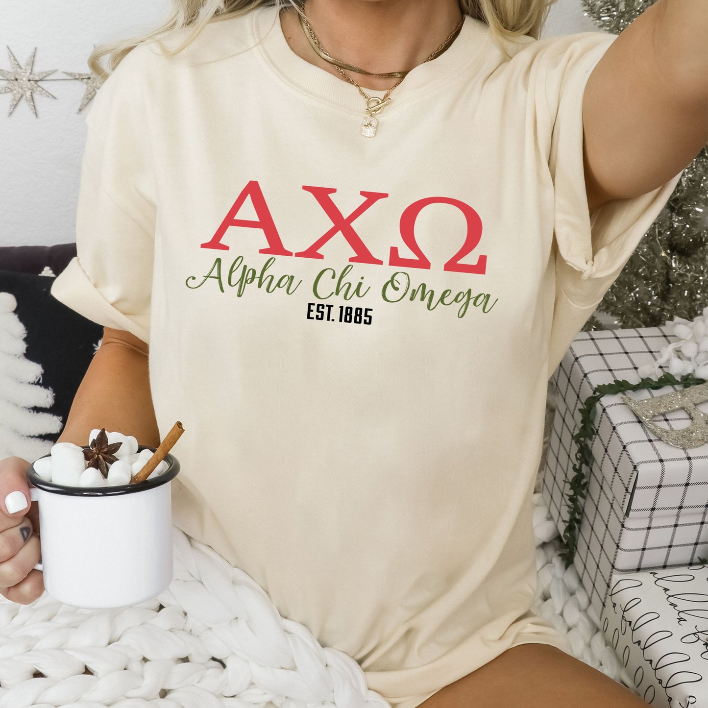 a woman sitting on a bed holding a cup of coffee