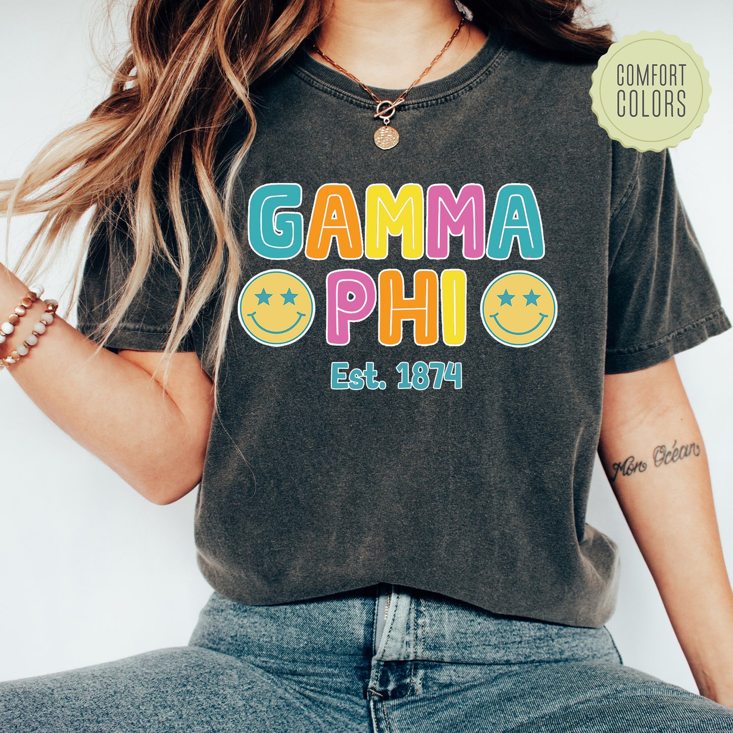 a woman wearing a t - shirt that says gama phi