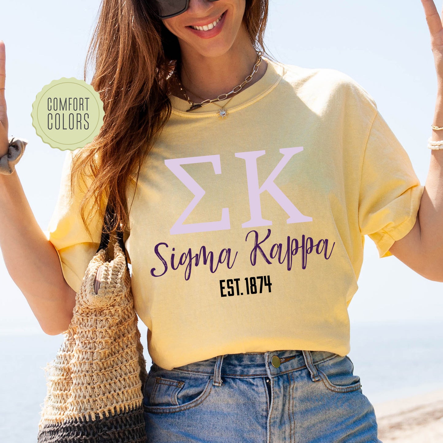 a woman in a yellow shirt holding up a peace sign