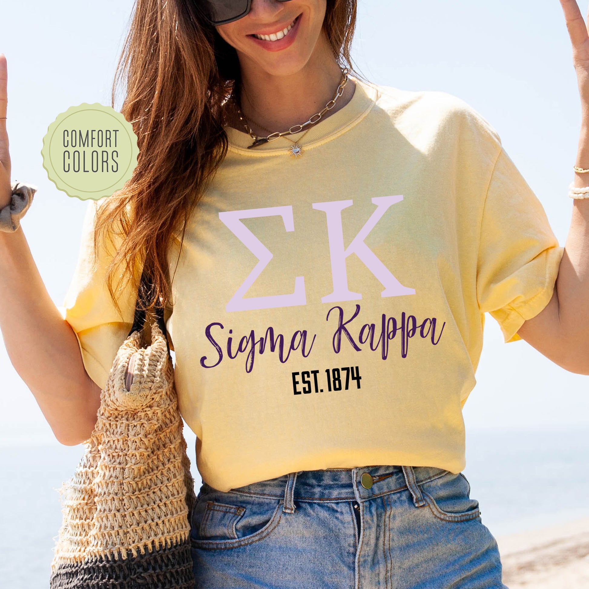 a woman in a yellow shirt holding up a peace sign