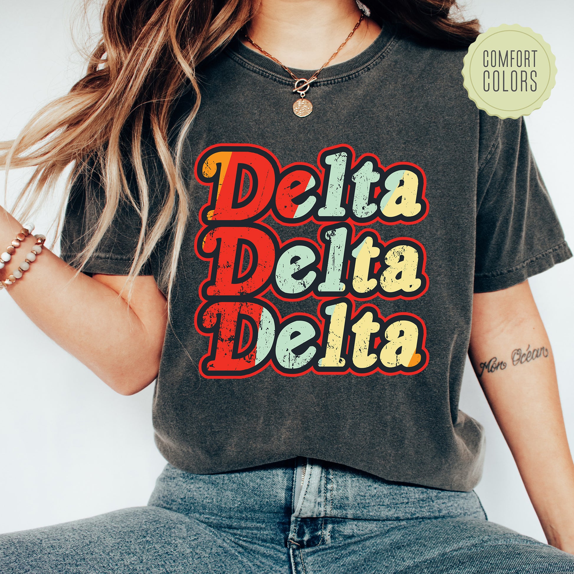 a woman wearing a t - shirt that says delta delta