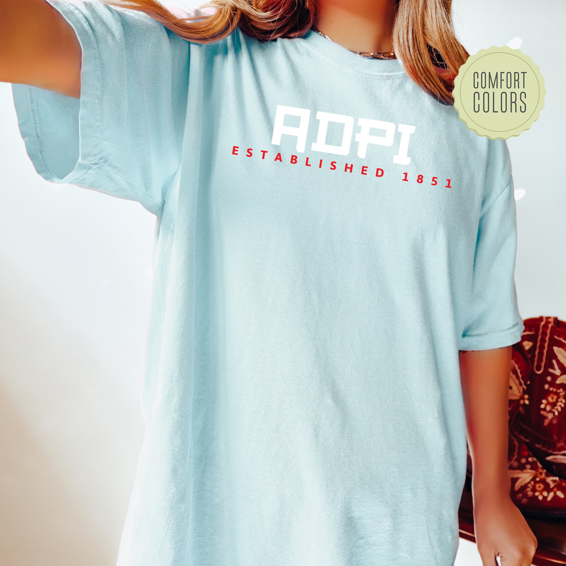 a woman wearing a light blue shirt with the word aorp on it