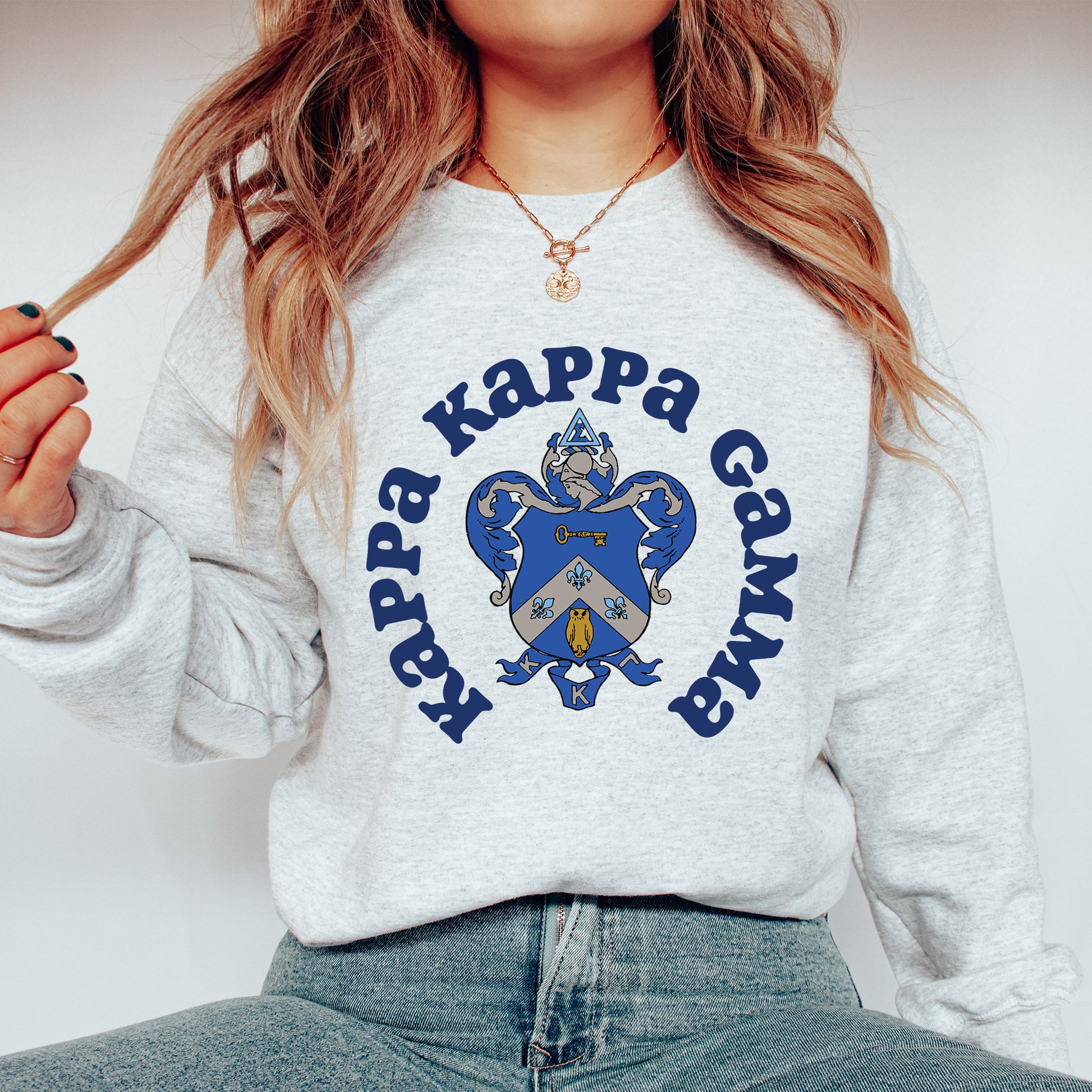 a woman wearing a sweatshirt that says happy kapp gang