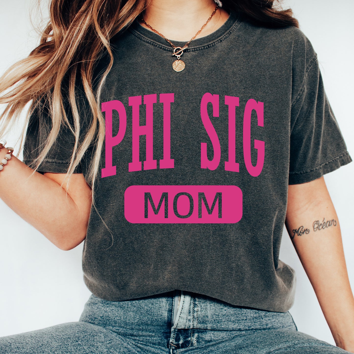 a woman wearing a phi sig mom shirt